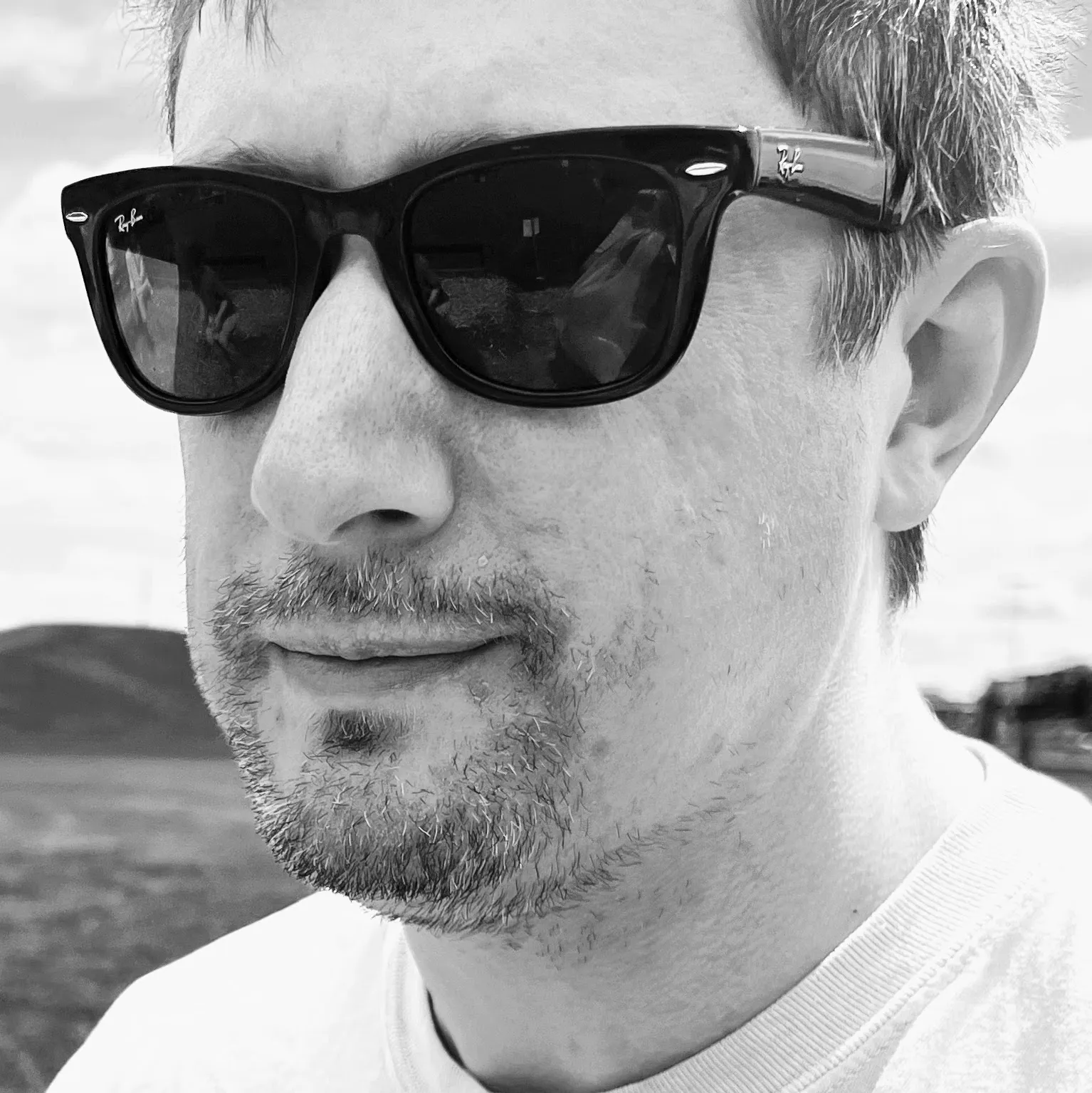 Black-and-white close-up portrait of Ethan J Lewis